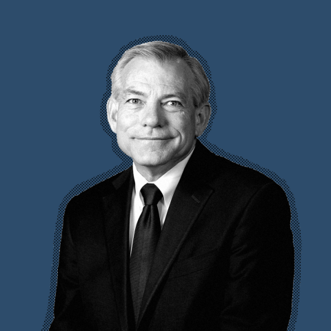 A black and white photo of Rep. David Schweikert against a blue background